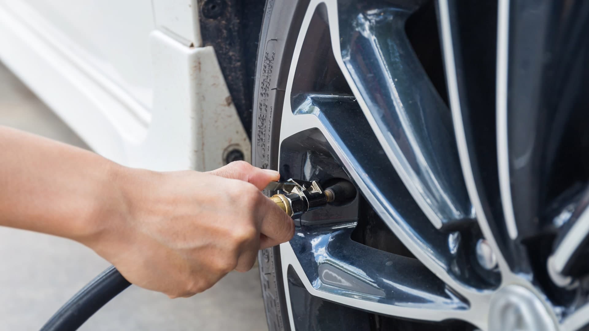 person putting air in tires